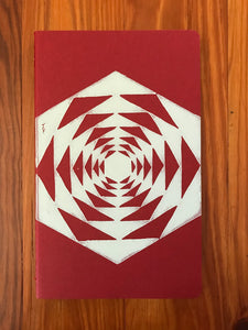 Hand block printed Moleskine Medium ruled chair journal in red. Printed in white ink on a geometric pattern.