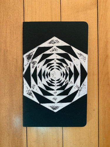 Hand block printed Moleskine Medium ruled chair journal in black. Printed in white ink on a geometric pattern. 
